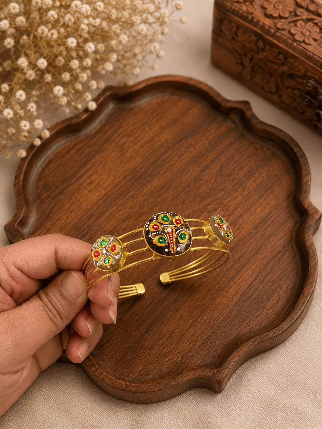 Gold-tone cuff bracelet with peacock enamel centerpiece and round side details