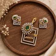 Gold-tone emerald green pendant and stud earring set with geometric square motif