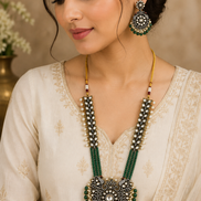 Gold-tone long necklace set with green-and-yellow beaded strands, ornate pendant, earrings