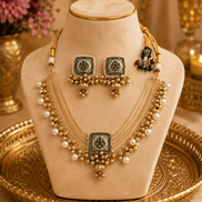 Gold-tone necklace set on bust: pearl layered choker with central pendant and jhumka earrings