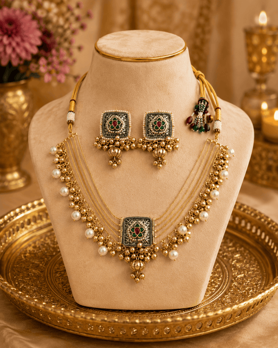 Gold-tone necklace set on bust: pearl layered choker with central pendant and jhumka earrings