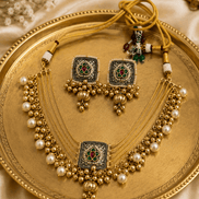 Gold-tone jewelry set with layered pearl necklace, square pendant, and dangling pearl earrings