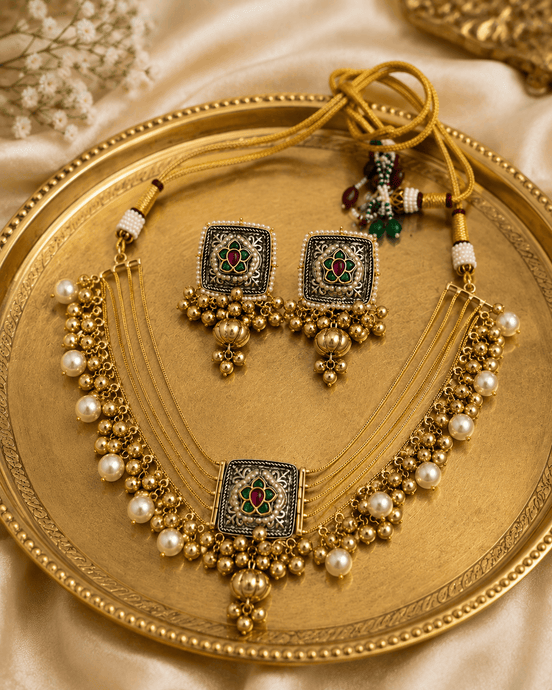Gold-tone jewelry set with layered pearl necklace, square pendant, and dangling pearl earrings