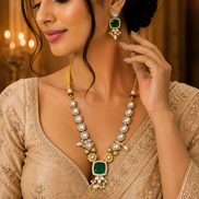 Gold-toned necklace and earrings set with teal square center and pearl drops