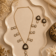 Black teardrop pendant necklace set with matching gold stud earrings and drop details
