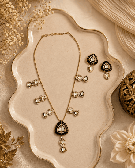 Black teardrop pendant necklace set with matching gold stud earrings and drop details