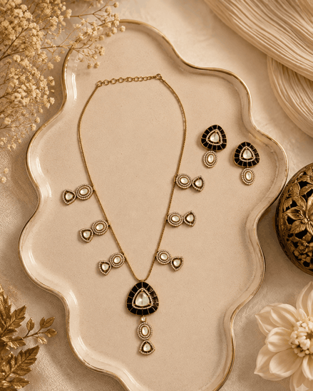 Black teardrop pendant necklace set with matching gold stud earrings and drop details