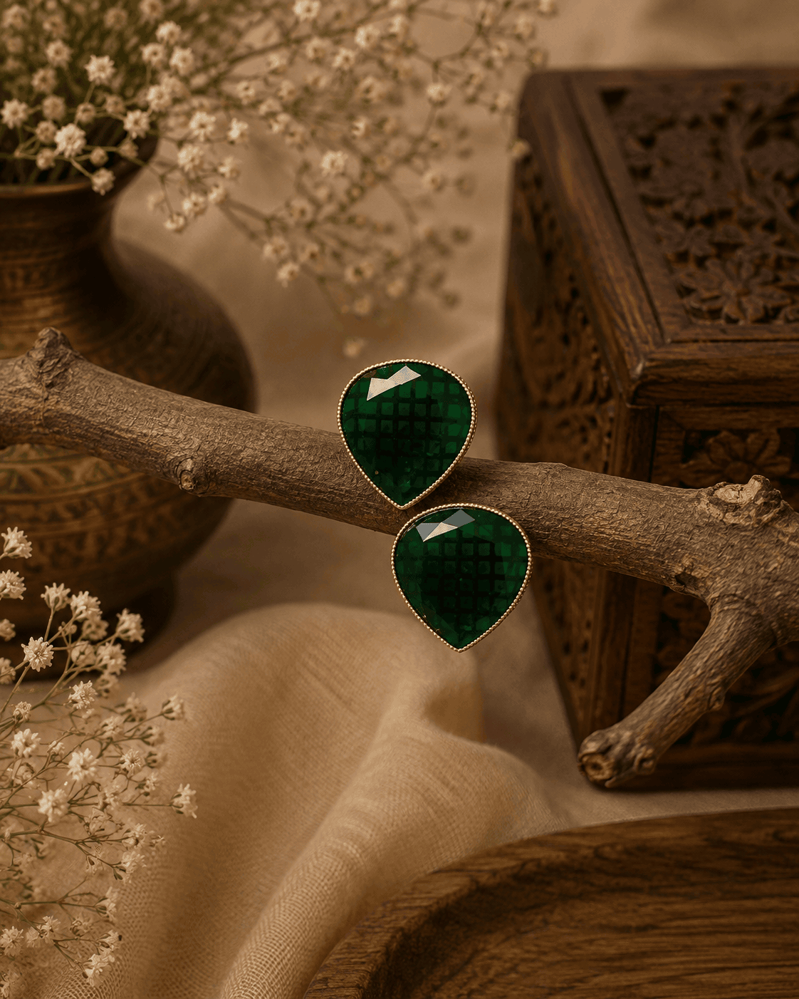 Dark green teardrop stud earrings with faceted stones