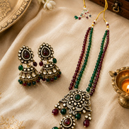 Brass-tone beaded long necklace with green and maroon chandelier drop earrings