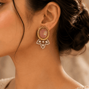 Pink oval stud earrings on-ear with gold halo and crystal bow dangles