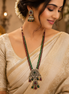 Long green and maroon bead necklace with matching chandelier earrings