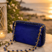 Blue beaded mini bag with gold chain shoulder strap and bead trim border