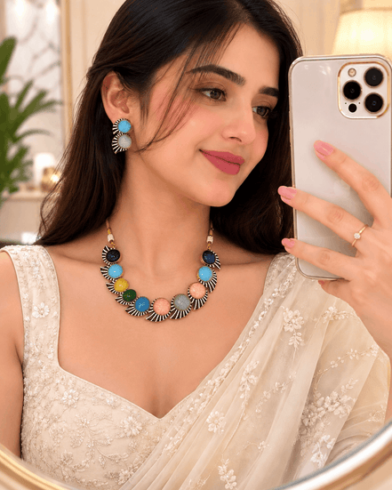 Multicolor stone necklace set with matching earrings, worn by a model in white