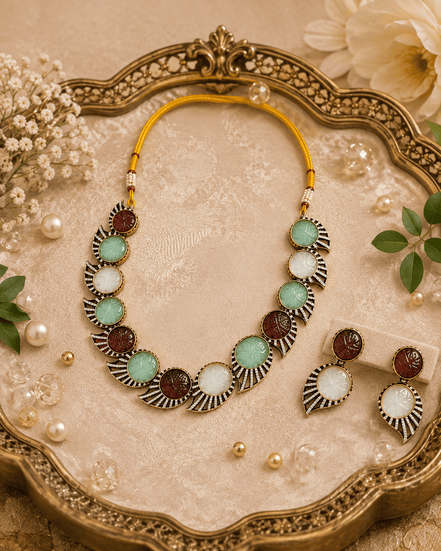 Multicolor stone choker necklace with matching earrings on an ornate tray