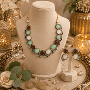 Multicolor stone necklace set on a bust with matching earrings