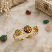 Gold-tone enamel cuff bracelet with peacock motif and three round charm medallions