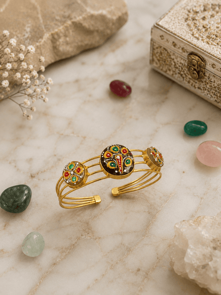 Gold-tone enamel cuff bracelet with peacock motif and three round charm medallions