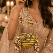 Kaira shell bag in gold with chain strap and shell charm tassels