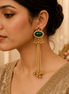 Gold oval gemstone tassel earrings with beaded drops, worn on a model in profile