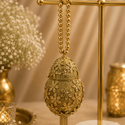 Gold Kiva potli on display stand, teardrop embroidered pouch with bead tassel fringe