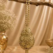 Gold Kiva potli with teardrop embroidery and bead tassel dangles from loop chain