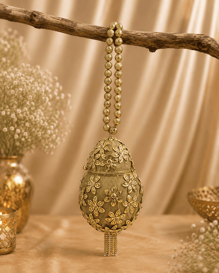 Gold Kiva potli with teardrop embroidery and bead tassel dangles from loop chain