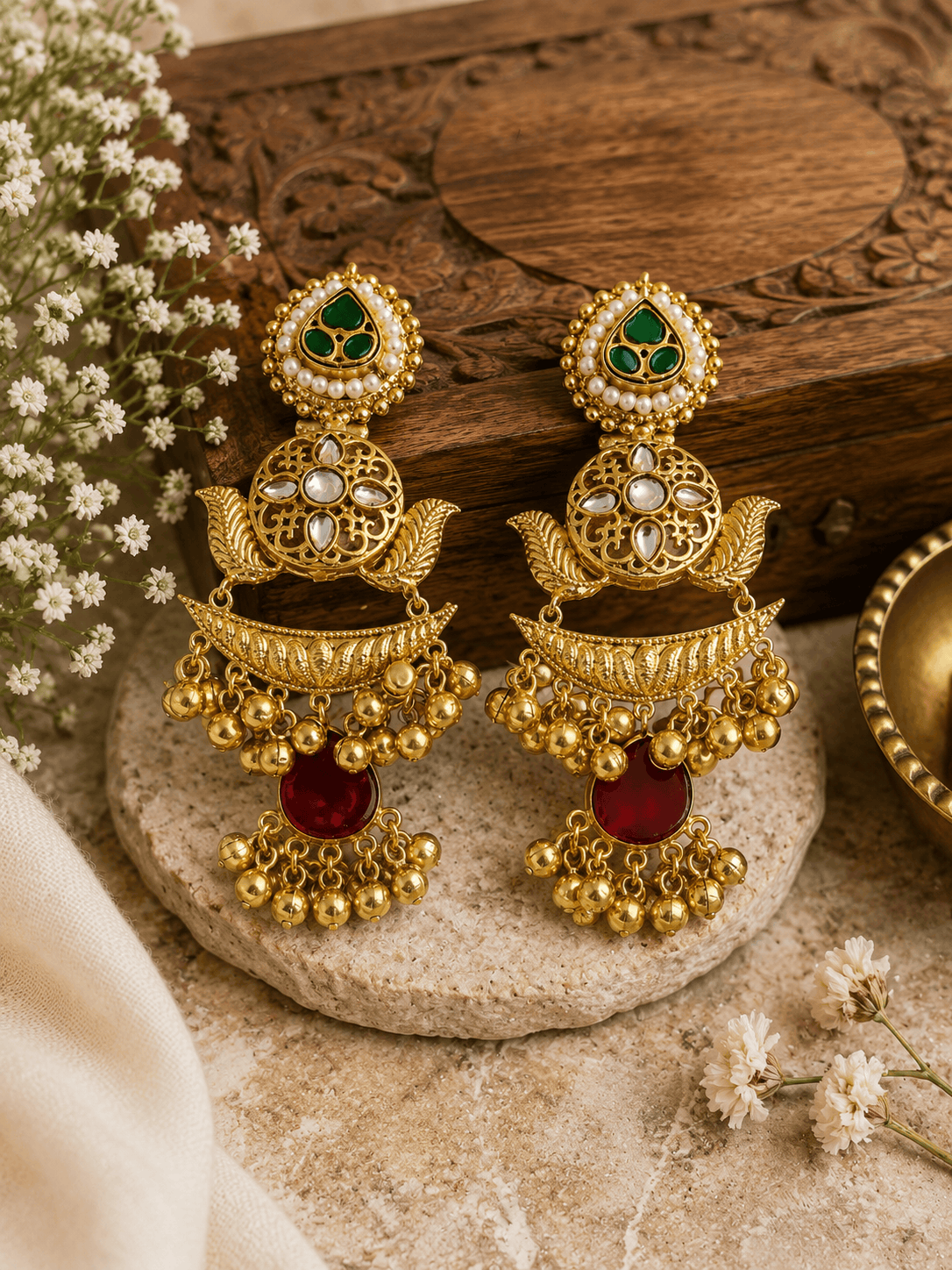 Gold kundan pearl-style jhumka earrings with green teardrop and red stones