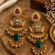 Gold kundan pearl-style jhumka earrings with purple and green teardrop stones