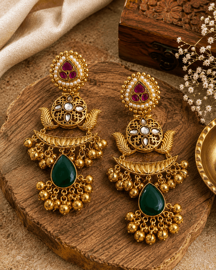 Gold kundan pearl-style jhumka earrings with purple and green teardrop stones
