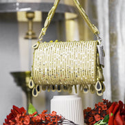 Beige beaded hobo bag with glittery teardrop charms and short top handles