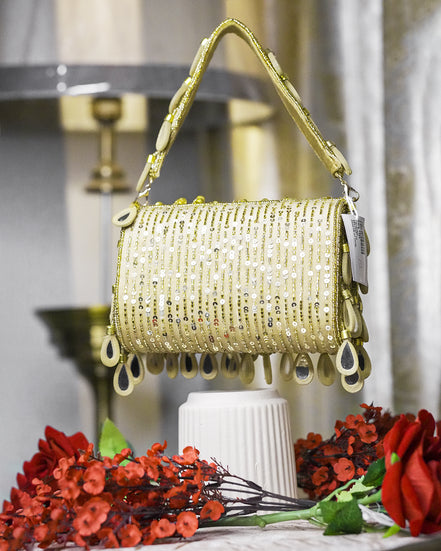 Beige beaded hobo bag with glittery teardrop charms and short top handles