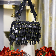 Black beaded hobo bag with layered teardrop bead fringe and top handles