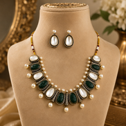 Mahira Heritage necklace set with green and black oval stones, white pearls, stud earrings.