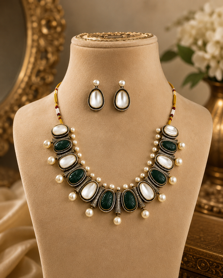 Mahira Heritage necklace set with green and black oval stones, white pearls, stud earrings.