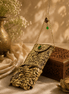 Gold filigree mobile clutch with chain strap, jeweled green and purple accents, coin tassel base