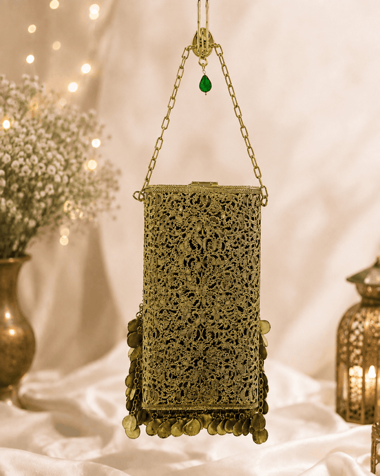Gold filigree mobile clutch with chain handle and green jeweled center, hanging coin fringe