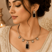 Gold-tone necklace with dark green and black square pendant and matching earrings