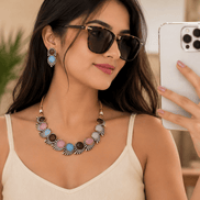 Multicolor stone necklace with matching hoop earrings, worn with sunglasses