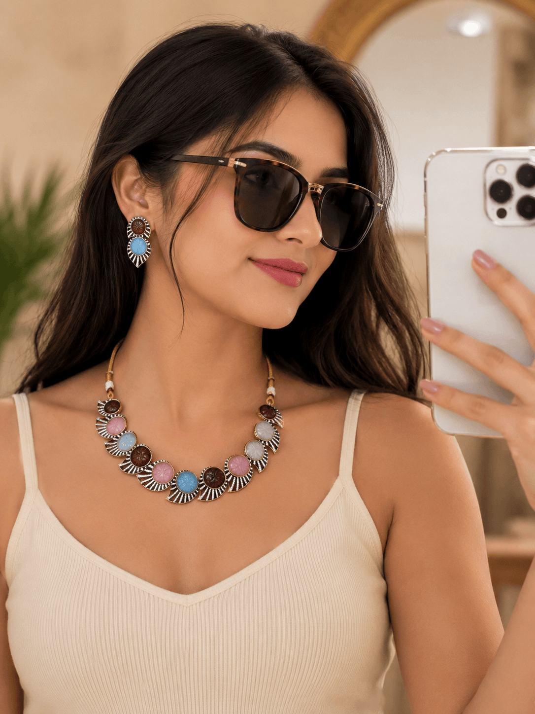 Multicolor stone necklace with matching hoop earrings, worn with sunglasses