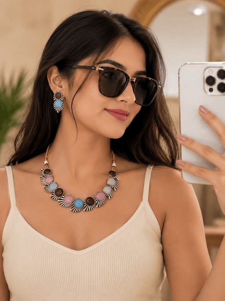 Multicolor stone necklace with matching hoop earrings, worn with sunglasses