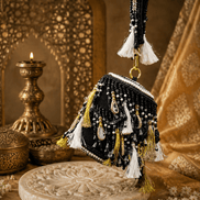 Black beaded potli bag with tassel fringe and gold-tone ring handle