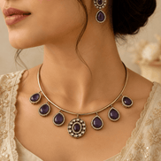 Gold-tone necklace with purple teardrop stones and matching drop earrings