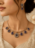 Gold-tone necklace with purple teardrop stones and matching drop earrings