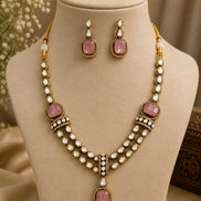 Gold kundan necklace set with pink oval pendants, layered pearl chain, and stud earrings