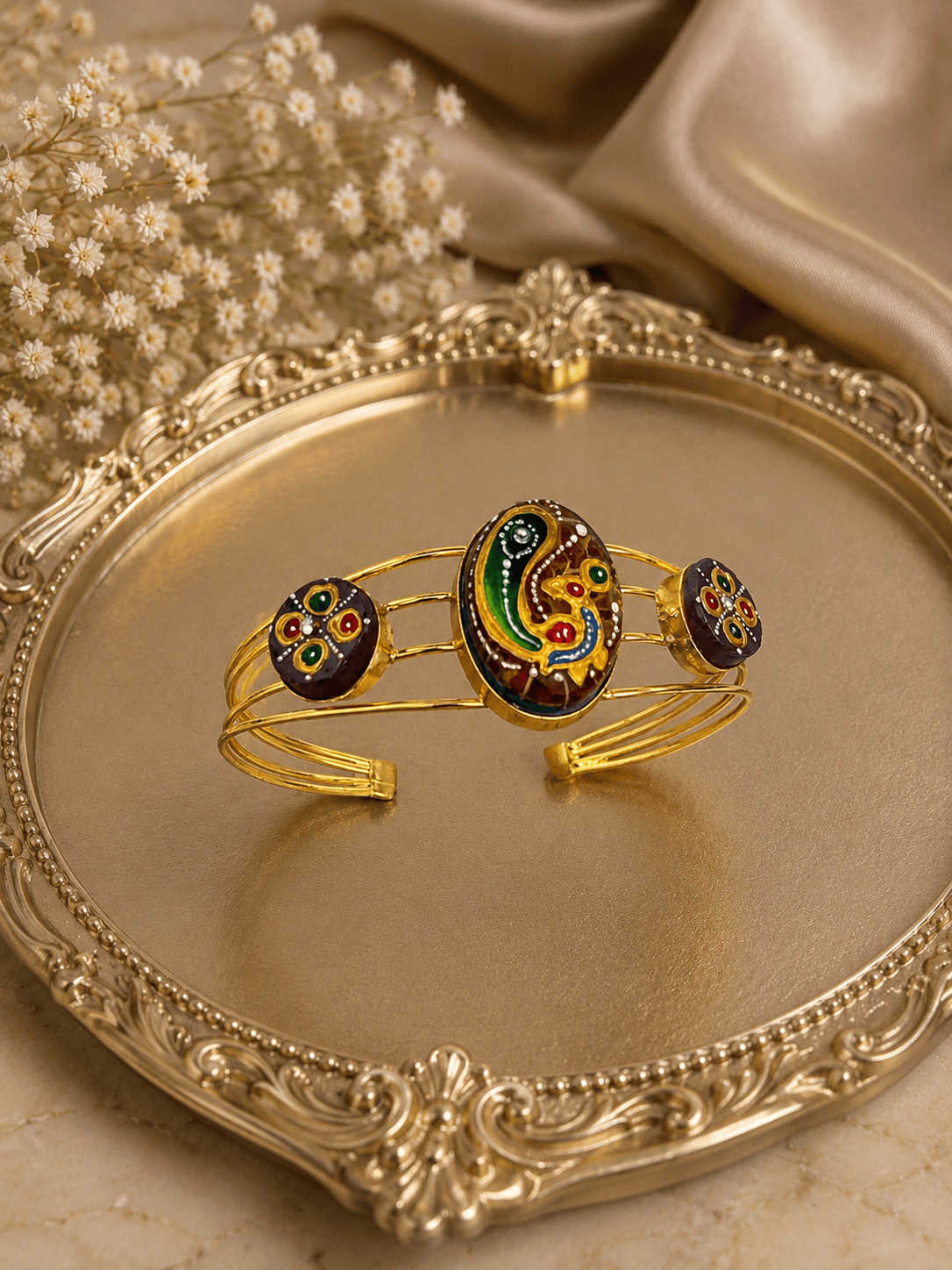 Gold-tone cuff bracelet with multicolor oval center and three round enamel accents