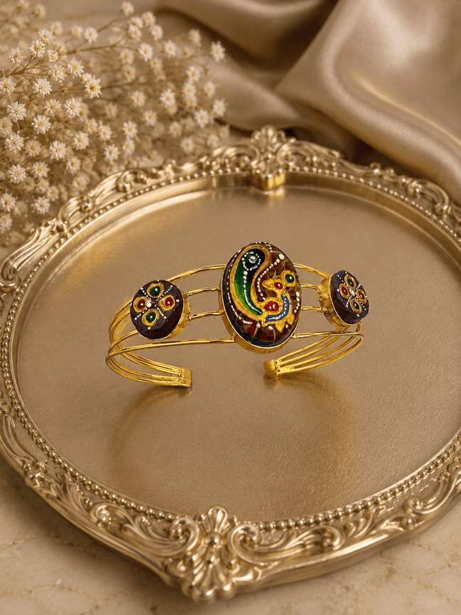 Gold-tone cuff bracelet with multicolor oval center and three round enamel accents