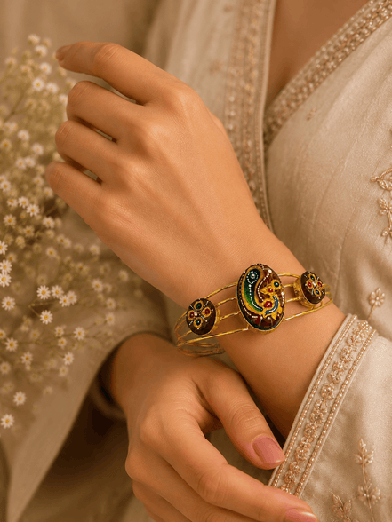 Gold-tone cuff bracelet with multicolor round and oval enamel detailing on wrist