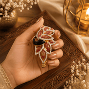 Gold kada with maroon and red stones, black centerpiece, dangling teardrop charm