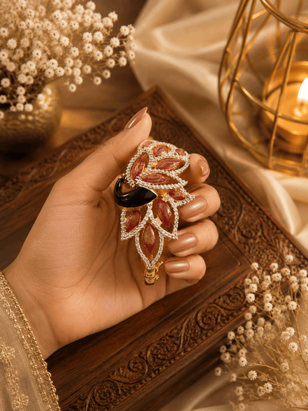 Gold kada with maroon and red stones, black centerpiece, dangling teardrop charm