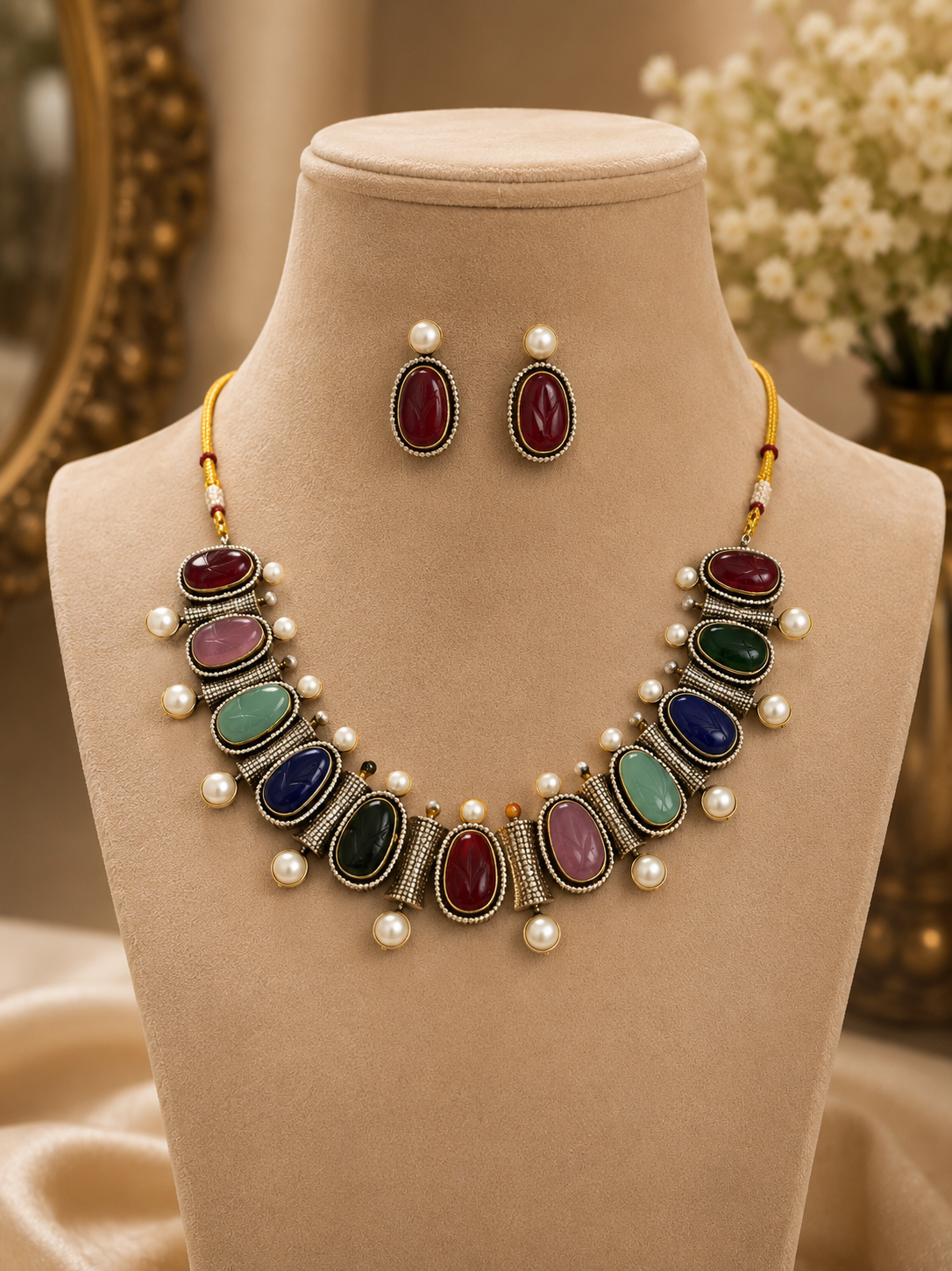 Mahira Heritage necklace set with red, green, and blue stones, pearl accents, stud earrings.